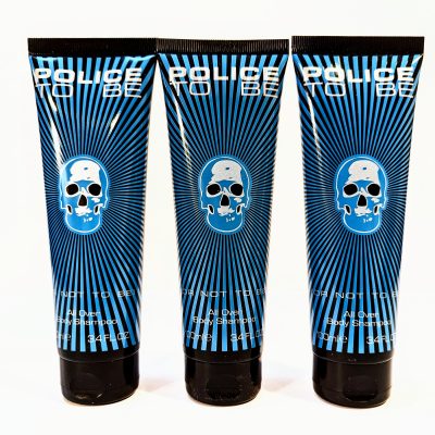 Three tubes of "Police To Be" all over body shampoo in 3.4 fl oz size with blue and black designs featuring a skull graphic on each tube.