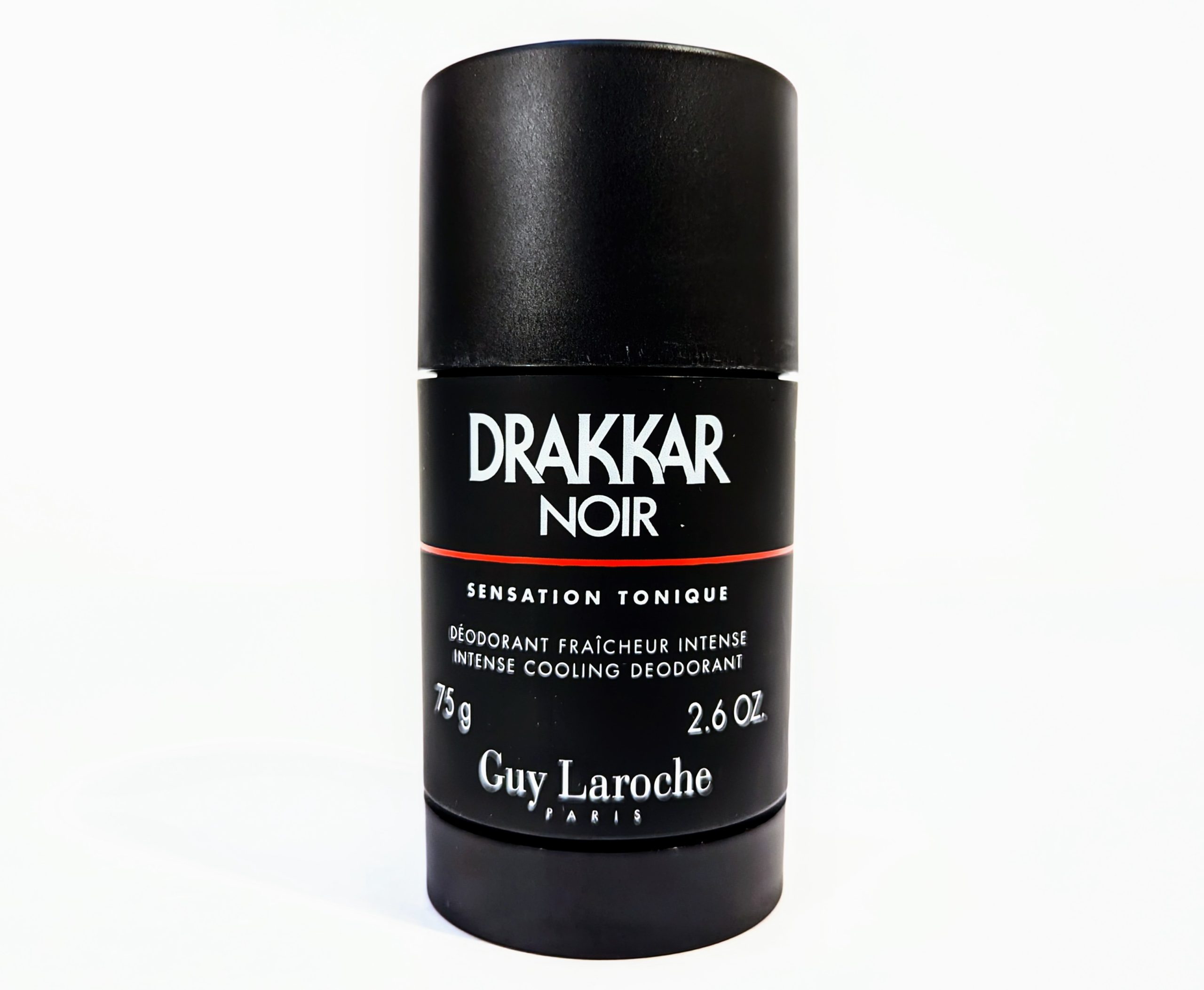 A black cylindrical container of Drakkar Noir deodorant by Guy Laroche, labeled “Sensation Tonique,” with a net weight of 75g (2.6 oz).