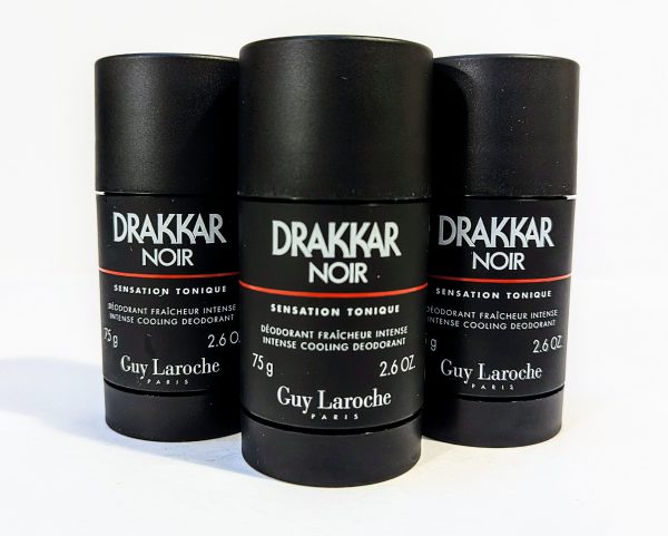 Three black cylindrical deodorant sticks labeled "Drakkar Noir" by Guy Laroche, each with a net weight of 2.6 oz (75 g). They are arranged side by side on a white surface.