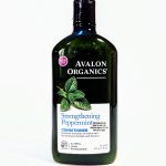 A bottle of Avalon Organics Strengthening Peppermint Conditioner with a new look label, claiming to improve elasticity of brittle hair. The bottle is green and contains 11 oz (312 g).