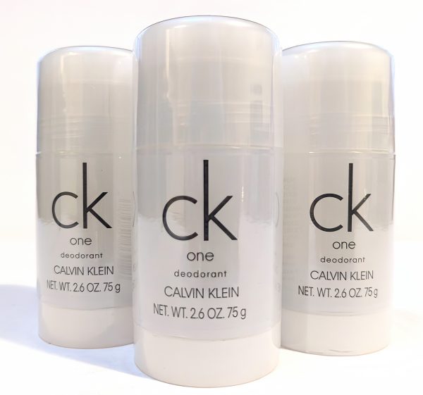 Three 2.6 oz sticks of Calvin Klein CK One deodorant are arranged side by side.