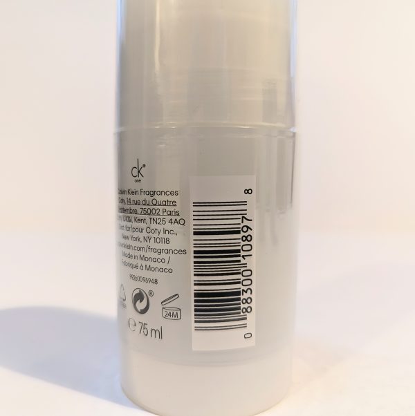 A cylindrical bottle of Calvin Klein fragrance showing a barcode, text about the product, and a 75 ml volume indicator.