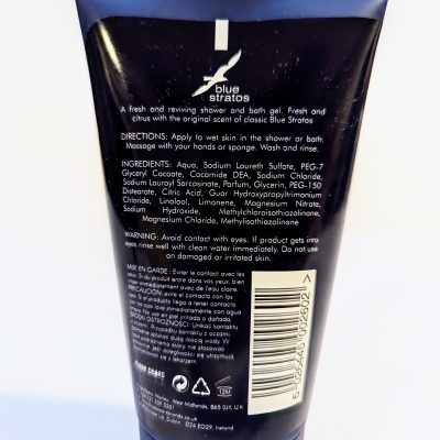 Back label of a Blue Stratos shower gel bottle showing directions for use, ingredients, and a warning. A barcode and the brand logo are also visible.