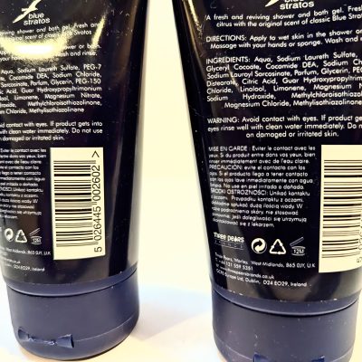 Two bottles of Blue Stratos shower and bath gel showing the back labels with directions, ingredients, warning, and product details printed in white text on dark backgrounds.