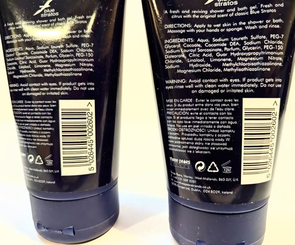 Two bottles of Blue Stratos shower and bath gel showing the back labels with directions, ingredients, warning, and product details printed in white text on dark backgrounds.