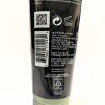 A close-up of a product's back label showing a QR code, barcode, text in multiple languages, a 12-month usage symbol, recycling information, and contact details.