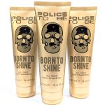 Three gold-colored tubes of "Police To Be Born To Shine All Over Body Shampoo," each containing 3.4 fl. oz (100 ml), are displayed with a skull design and black text on the packaging.