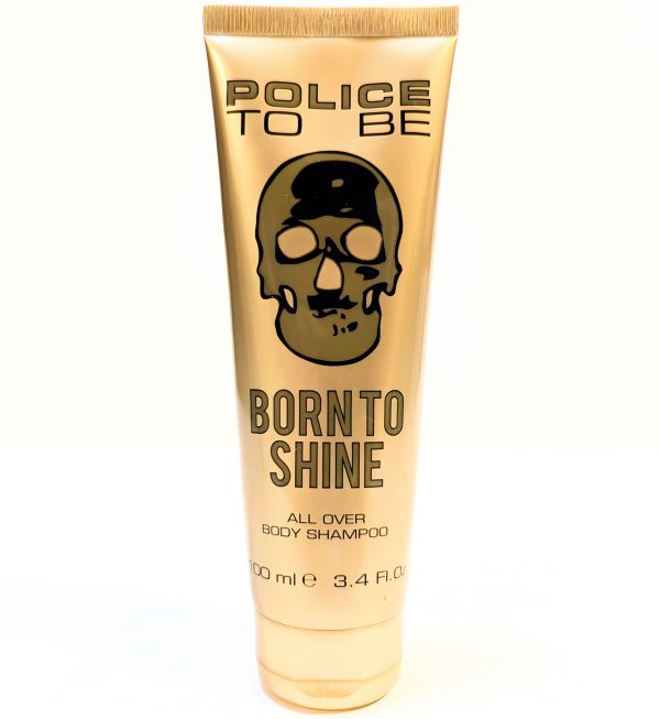 A beige tube labeled "Police To Be Born to Shine All Over Body Shampoo" with a black skull logo. The tube contains 100 ml (3.4 fl. oz.) of product.