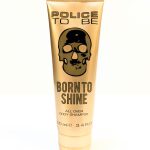 A beige tube labeled "Police To Be Born to Shine All Over Body Shampoo" with a black skull logo. The tube contains 100 ml (3.4 fl. oz.) of product.