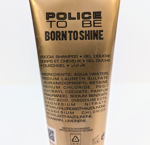 A gold tube of Police to Be Born to Shine shower gel. The back label lists ingredients including aqua, sodium laureth sulfate, and parfum, among others, in multiple languages.