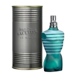 A cylindrical metal container labeled with "Jean Paul Gaultier Le Male Eau de Toilette EDT 125ml Spray" next to a torso-shaped perfume bottle featuring a blue and white striped design.