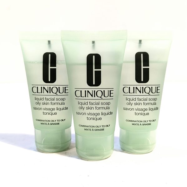 Three tubes of Clinique liquid facial soap for oily skin are arranged in a row. The packaging is light green, and each tube is labeled with the product name and usage instructions in English and French. Three tubes of Clinique liquid facial soap for oily skin are arranged in a row. The packaging is light green, and each tube is labeled with the product name and usage instructions in English and French.