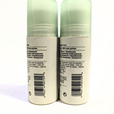 Two identical, cylindrical deodorant containers with light green caps, shown from the back, displaying labels in multiple languages and barcodes.