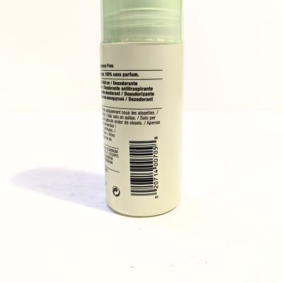 A close-up image of a cylindrical deodorant bottle displaying instructions and a barcode. The upper part of the bottle is semi-transparent green. Text is visible in multiple languages.