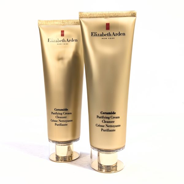 Two gold-colored tubes of Elizabeth Arden Ceramide Purifying Cream Cleanser with caps, shown against a white background.