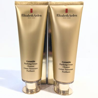 Two gold tubes of Elizabeth Arden Ceramide Purifying Cream Cleanser are shown side by side. The product name and description are printed on the front of each tube.