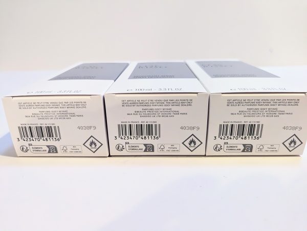 Three product boxes with barcodes and hazard symbols are displayed in a row on a white surface.