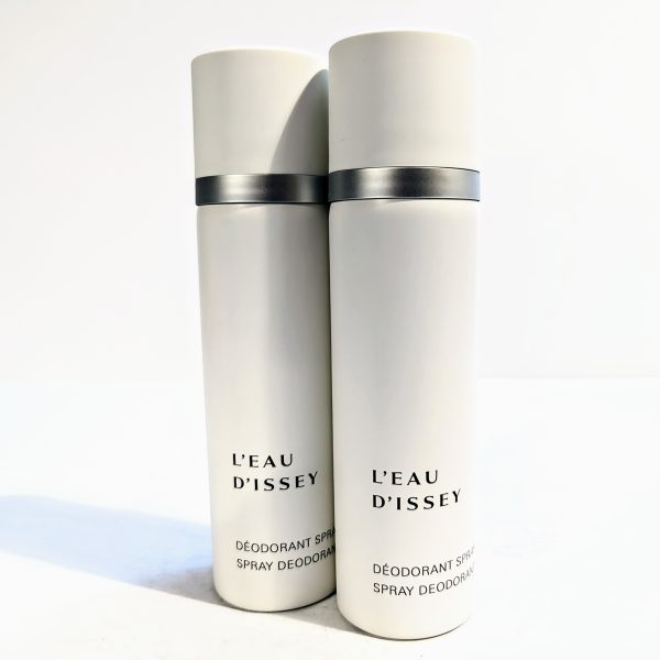 Two white cylindrical cans of L'Eau d'Issey spray deodorant are positioned side by side against a plain background.