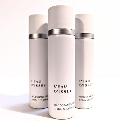 Three white cylindrical bottles of L’Eau d’Issey deodorant spray are displayed against a plain background.