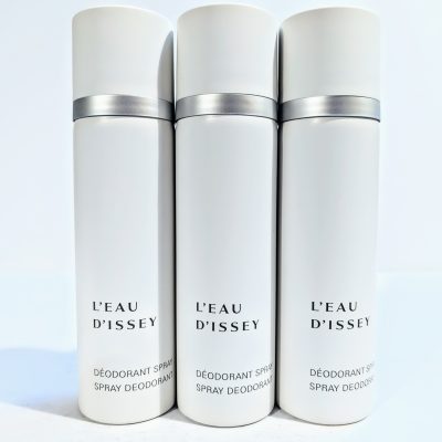 Three white cans of L'Eau D'Issey spray deodorant with gray caps are standing side by side against a plain background.