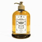 A large amber bottle with a pump dispenser labeled "Penhaligon's Highgrove Bouquet Body & Hand Wash," set against a white background.