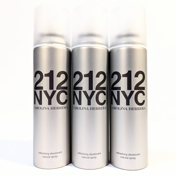 Three silver cans of 212 NYC Carolina Herrera refreshing deodorant natural spray are arranged side by side against a white background. Three silver cans of 212 NYC Carolina Herrera refreshing deodorant natural spray are arranged side by side against a white background.