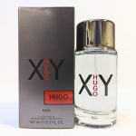 A 100ml bottle of Hugo Boss XY Eau de Toilette for men is displayed next to its black and silver packaging box. The product's branding is prominently featured on both the bottle and the box.