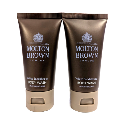 Two identical brown tubes of Molton Brown White Sandalwood Body Wash, each labeled "Made in England" on the lower part of the tubes.
