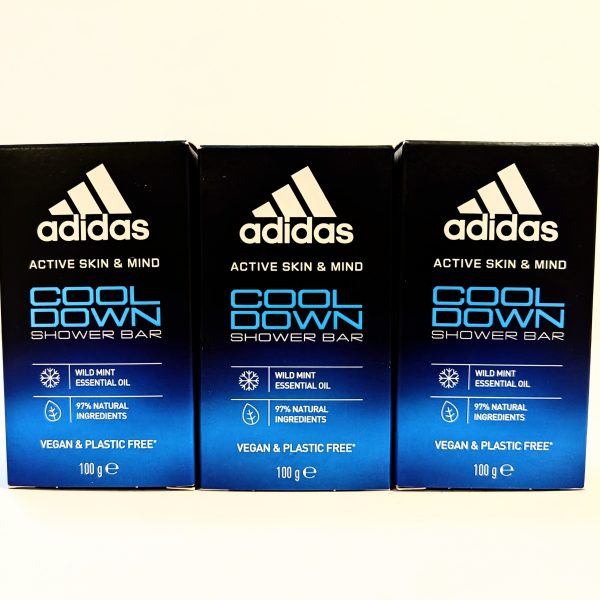 Three boxes of Adidas Cool Down shower bar, featuring wild mint essential oil, 97% natural ingredients, and labeled as vegan and plastic-free. Each box is 100g.