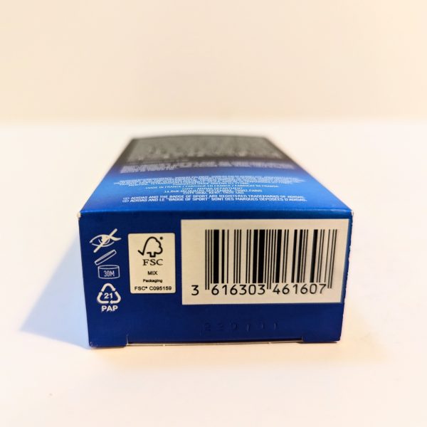 Close-up of a product box showing a barcode, recycling symbols, and an FSC certification icon on a blue background.