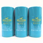 Three teal-colored deodorant sticks labeled "Hollister California Wave 2 For Him," each containing 2.5 oz (75 g) of product, are arranged side by side.