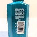 Back of a blue-colored plastic bottle showing the detailed list of ingredients, a barcode, recycling symbols, and product origin information.