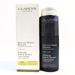 Clarins Aroma Relaxing Bath & Shower Concentrate bottle (200 ml) with essential oils next to its packaging box.