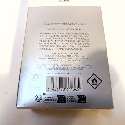 The back of an Issey Miyake perfume box listing ingredients, company information, barcode, and recycling symbols.