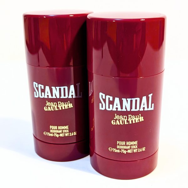 Two red cylindrical deodorant sticks labeled "Scandal Jean Paul Gaultier Pour Homme" with a 75ml (2.6 oz) capacity each, placed against a plain background.