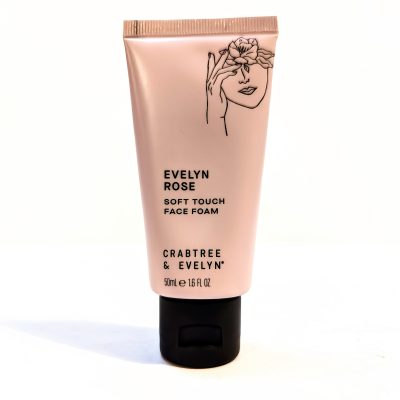 A 50ml tube of Crabtree & Evelyn Evelyn Rose Soft Touch Face Foam with a black cap and a floral illustration on a light pink background.