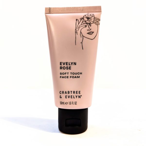 A 50ml tube of Crabtree & Evelyn Evelyn Rose Soft Touch Face Foam with a black cap and a floral illustration on a light pink background. A 50ml tube of Crabtree & Evelyn Evelyn Rose Soft Touch Face Foam with a black cap and a floral illustration on a light pink background.