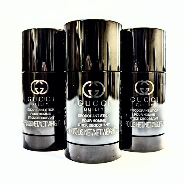 Two Gucci Guilty Deodorant Sticks for Men, 75ml in black packaging, arranged in a triangular formation. Two Gucci Guilty Deodorant Sticks for Men, 75ml in black packaging, arranged in a triangular formation.