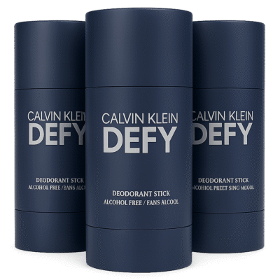 Three Calvin Klein Defy Deodorant Sticks for Men, 75ml each, in navy blue packaging are shown with one fully visible in front and the others behind. Labels display "Alcohol Free.