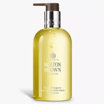 A clear 300ml bottle of Molton Brown Orange & Bergamot Hand Wash with a pump dispenser, featuring yellow liquid.