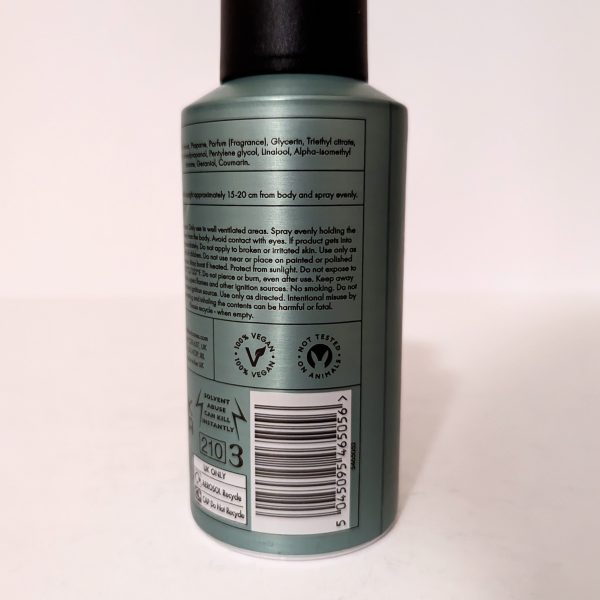 A green cylindrical spray bottle with a black cap. The label lists ingredients, usage instructions, recycling symbols, a barcode, and the number 2103.