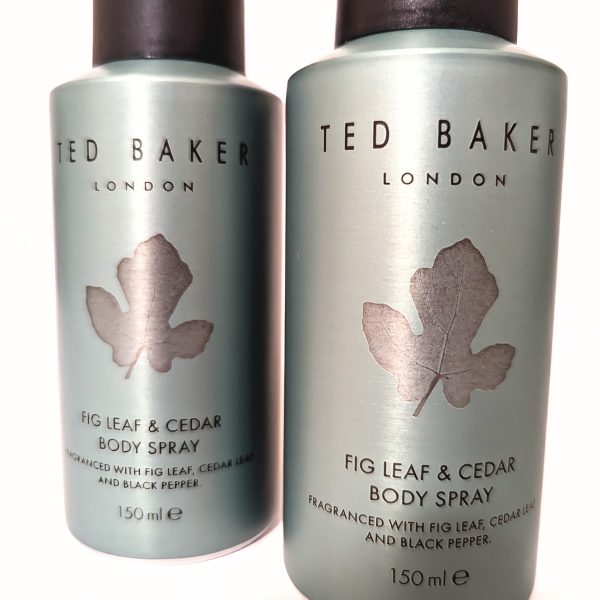 Two bottles of Ted Baker Fig Leaf & Cedar body spray, each 150ml. Silver packaging with leaf design.