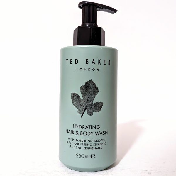 A bottle of Ted Baker London Hydrating Hair & Body Wash with hyaluronic acid, featuring a black leaf design, 250 ml.