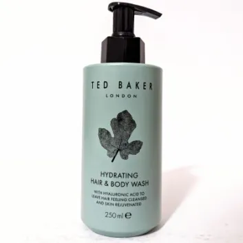 A bottle of Ted Baker London Hydrating Hair & Body Wash with hyaluronic acid, featuring a black leaf design, 250 ml.