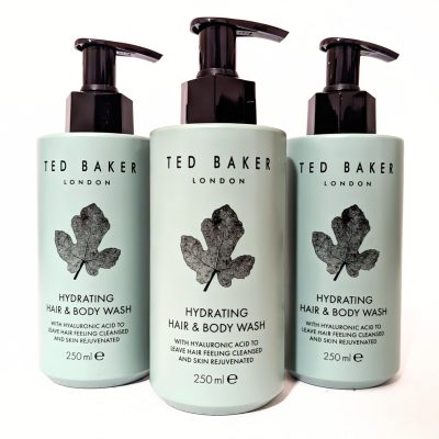 Three bottles of Ted Baker London Hydrating Hair & Body Wash, each 250 ml, with black pump dispensers and mint green labels featuring a black leaf design.