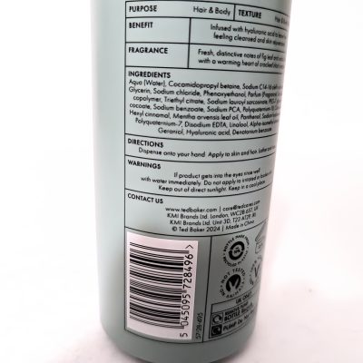 A bottle displaying a list of ingredients and usage instructions. Includes contact information and a barcode at the bottom.