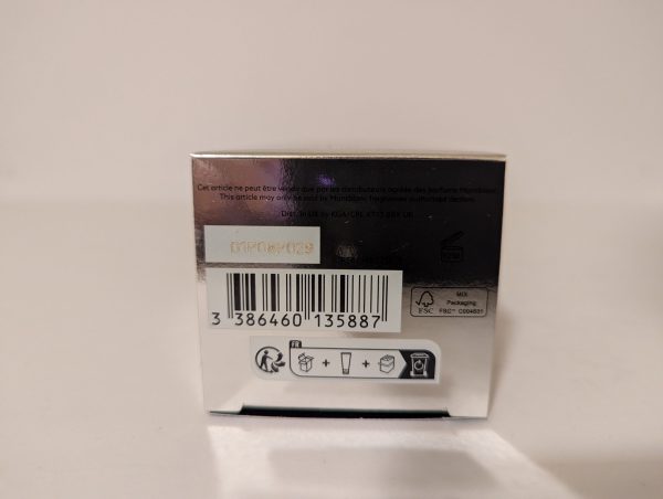 Back of a product box showing a barcode, various recycling symbols, and printed text in multiple languages.