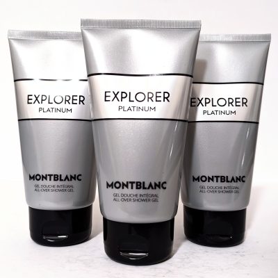 Three silver tubes of Montblanc Explorer Platinum all-over shower gel are arranged upright on a white surface.