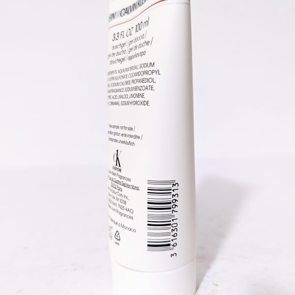 White cosmetic bottle with text and barcode on the back label, standing upright on a white surface.