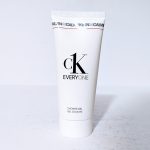 A white tube of CK Everyone shower gel stands upright on a light surface.